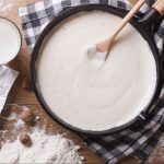 A skillet with homemade Bechamel Sauce.