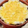 A bowl of Cheddar Mashed Potatoes on top of ground beef