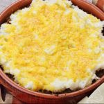 A bowl of Cheddar Mashed Potatoes on top of ground beef