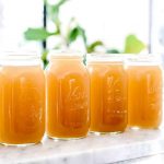 Clear Poultry Stock in jars on a counter