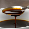Spooning some delicious Demi Glace Sauce from a bowl