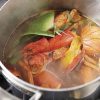 A chef making a pot of Lobster Stock